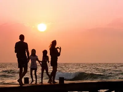 Family on dock in sunset